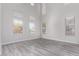Bright, airy living room with vaulted ceilings, multiple windows and wood flooring at 18868 E Canary Way, Queen Creek, AZ 85142
