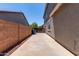 The side yard with a concrete path and rock landscaping offers a tidy and low-maintenance outdoor space at 18868 E Canary Way, Queen Creek, AZ 85142