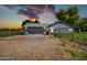 Charming home exterior featuring a fenced yard and gravel driveway at 20042 W Dunlap Rd, Buckeye, AZ 85326