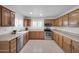 Well-appointed kitchen with stainless steel appliances, light countertops, and natural wood cabinets offering style and functionality at 20042 W Dunlap Rd, Buckeye, AZ 85326