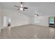 Open living room with tile floors, neutral walls, and lots of windows making it feel bright and inviting at 20042 W Dunlap Rd, Buckeye, AZ 85326