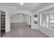 Open-concept living room with neutral color palette, tile flooring, and plenty of natural light through plantation shutters at 20042 W Dunlap Rd, Buckeye, AZ 85326