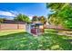 Charming playhouse with porch offers a fun and imaginative space for in a grassy backyard at 20042 W Dunlap Rd, Buckeye, AZ 85326