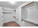 A walk-in closet with built-in shelving and wooden rods at 20042 W Dunlap Rd, Buckeye, AZ 85326