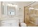Updated bathroom with modern vanity, framed mirror, and walk-in shower, offering a clean and functional space at 2116 W Marlette Ave, Phoenix, AZ 85015