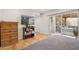 Bedroom with hardwood floors, tv, and patio access at 2116 W Marlette Ave, Phoenix, AZ 85015