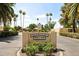 Orangaire Villas entrance sign with manicured landscaping and mature palm trees at 2116 W Marlette Ave, Phoenix, AZ 85015