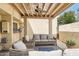 Inviting covered patio featuring comfortable seating, neutral tones, and a ceiling fan for relaxed outdoor living at 2116 W Marlette Ave, Phoenix, AZ 85015