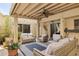 Comfortable covered patio with wicker furniture, ceiling fan, and stucco walls for outdoor relaxation and entertainment at 2116 W Marlette Ave, Phoenix, AZ 85015