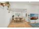 Dining area open to the living room features a modern table set for four and decor shelving at 2116 W Marlette Ave, Phoenix, AZ 85015