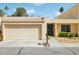 Charming single-story home featuring a tan exterior, a two-car garage, and a well-manicured lawn at 2116 W Marlette Ave, Phoenix, AZ 85015