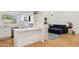 Modern kitchen with white cabinets, quartz countertops, stainless steel appliances, and hardwood flooring at 2116 W Marlette Ave, Phoenix, AZ 85015