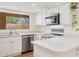 Bright kitchen features quartz counters, stainless appliances, and bright window at 2116 W Marlette Ave, Phoenix, AZ 85015
