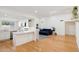 Open floor plan with living room featuring hardwood floors that connects to the bright kitchen at 2116 W Marlette Ave, Phoenix, AZ 85015