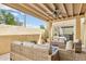 Relaxing covered patio featuring comfortable seating, ceiling fan, and sliding glass doors at 2116 W Marlette Ave, Phoenix, AZ 85015