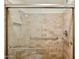 Bathroom features walk in shower with glass door, stone tile and handrails at 2116 W Marlette Ave, Phoenix, AZ 85015