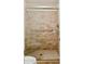 Bathroom features walk in shower with glass door, stone tile and handrails at 2116 W Marlette Ave, Phoenix, AZ 85015