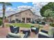 The backyard offers an outdoor seating area, grill, pool, and lush lawn at 2218 E Anchor Dr, Gilbert, AZ 85234