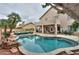 Beautiful backyard with sparkling pool, lounging area, and outdoor seating for entertaining at 2218 E Anchor Dr, Gilbert, AZ 85234