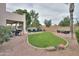 This backyard boasts a patio, pool, manicured lawn, and comfortable seating area at 2218 E Anchor Dr, Gilbert, AZ 85234