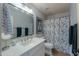 Bright bathroom with white countertops, decorative mirror and shower with a stylish curtain at 2218 E Anchor Dr, Gilbert, AZ 85234