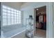 Bathroom with tub, marble backsplash and open closet at 2218 E Anchor Dr, Gilbert, AZ 85234