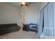 Spacious bedroom with a ceiling fan and ample space for storage and relaxation at 2218 E Anchor Dr, Gilbert, AZ 85234
