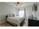 Bedroom with a cozy bed, ceiling fan, and mounted TV for comfortable living at 2218 E Anchor Dr, Gilbert, AZ 85234