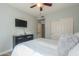 Bedroom featuring neutral tones, a ceiling fan, closet, and connecting door at 2218 E Anchor Dr, Gilbert, AZ 85234