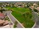 Aerial shot of a community park that includes a large grassy field and mature landscaping at 2218 E Anchor Dr, Gilbert, AZ 85234