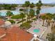 Aerial view of a community pool with a hot tub, patios, lush landscaping, and resort-style amenities at 2218 E Anchor Dr, Gilbert, AZ 85234