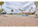 Large, rectangular community pool surrounded by palm trees and lounge chairs at 2218 E Anchor Dr, Gilbert, AZ 85234