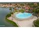 Expansive community pool area featuring a sandy beach, multiple lounge chairs, and a poolside bar under shade at 2218 E Anchor Dr, Gilbert, AZ 85234