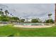 Expansive community pool surrounded by grass and sandy beach areas at 2218 E Anchor Dr, Gilbert, AZ 85234