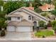 This two-story home includes an attached three-car garage and well-maintained landscaping at 2218 E Anchor Dr, Gilbert, AZ 85234