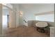 Second floor hallway with carpet, with a chair, and an open doorway to the living room at 2218 E Anchor Dr, Gilbert, AZ 85234