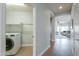 Hallway view into laundry room with modern appliances and ample space at 2218 E Anchor Dr, Gilbert, AZ 85234