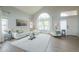Bright living room with vaulted ceilings, large windows, and comfortable white seating at 2218 E Anchor Dr, Gilbert, AZ 85234