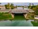Scenic view of a neighborhood bridge over a tranquil waterway, surrounded by lush greenery and upscale homes at 2218 E Anchor Dr, Gilbert, AZ 85234