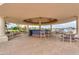 Outdoor lounge with a bar and ample seating, ideal for social gatherings at 2218 E Anchor Dr, Gilbert, AZ 85234