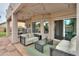 Cozy covered patio with comfortable seating and a view of the lush backyard at 2218 E Anchor Dr, Gilbert, AZ 85234