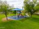 Community playground with colorful play structures, shaded area, and surrounding green space for recreational activities at 2218 E Anchor Dr, Gilbert, AZ 85234