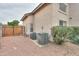 A side yard features a wooden gate, gravel cover, and two air conditioning units at 2218 E Anchor Dr, Gilbert, AZ 85234