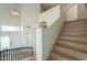 Staircase with wood-look steps leading up to a second floor, featuring modern light fixture, and a wall nook at 2218 E Anchor Dr, Gilbert, AZ 85234