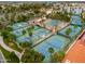 Aerial view of multiple tennis courts with palm tree landscaping in a well-maintained community setting at 2218 E Anchor Dr, Gilbert, AZ 85234