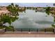 Scenic waterfront view of homes along the lake with lush greenery and palm trees, creating a serene and picturesque setting at 2218 E Anchor Dr, Gilbert, AZ 85234