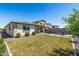 Backyard boasts a well-manicured lawn, patio with furniture, and privacy wall at 22491 E Mewes Rd, Queen Creek, AZ 85142