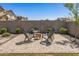 Inviting backyard seating area with a fire pit, perfect for relaxing and entertaining outdoors at 22491 E Mewes Rd, Queen Creek, AZ 85142