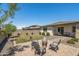 Beautifully landscaped backyard showcasing a patio with a fire pit, a lush lawn, and comfortable seating at 22491 E Mewes Rd, Queen Creek, AZ 85142