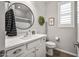 Stylish bathroom with shiplap walls, modern fixtures, and a round mirror at 22491 E Mewes Rd, Queen Creek, AZ 85142